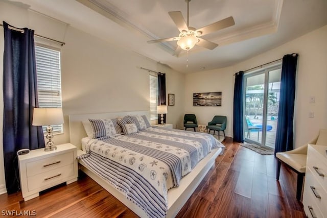 bedroom with a raised ceiling, access to exterior, ceiling fan, and dark hardwood / wood-style floors