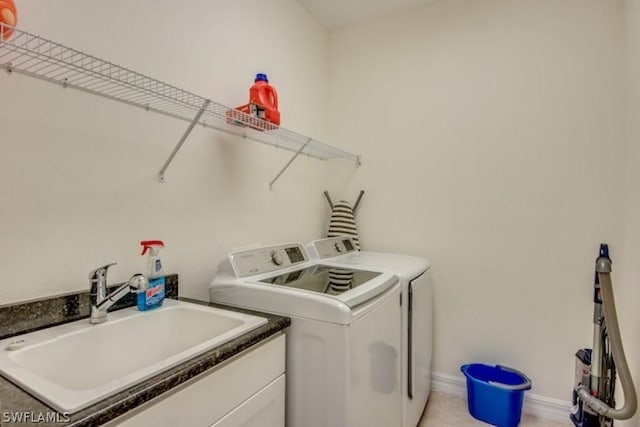 laundry room with separate washer and dryer and sink