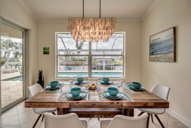 tiled dining room with ornamental molding, a wealth of natural light, and a chandelier