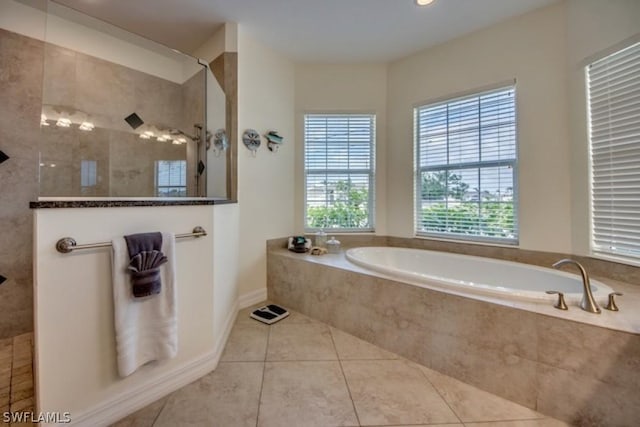 bathroom featuring tile patterned floors and separate shower and tub