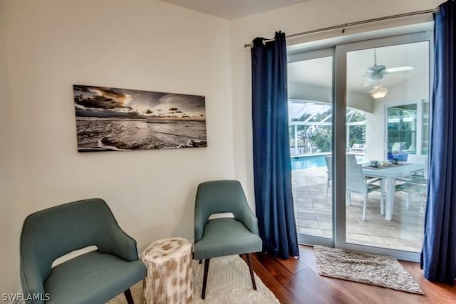 living area with ceiling fan and hardwood / wood-style flooring