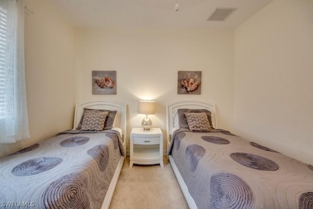 bedroom with light carpet and multiple windows