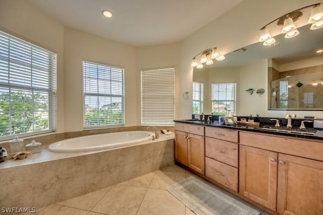 bathroom with vanity, tile patterned floors, a wealth of natural light, and separate shower and tub