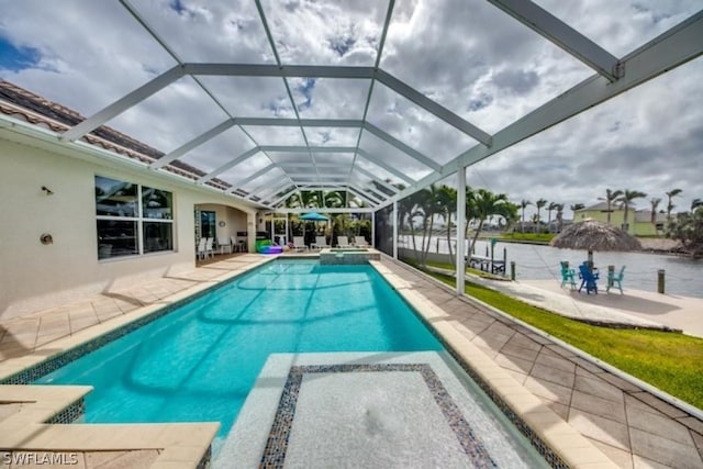 view of swimming pool featuring a water view, glass enclosure, and a patio area