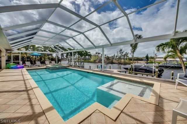 view of swimming pool with a lanai, an in ground hot tub, a water view, and a patio