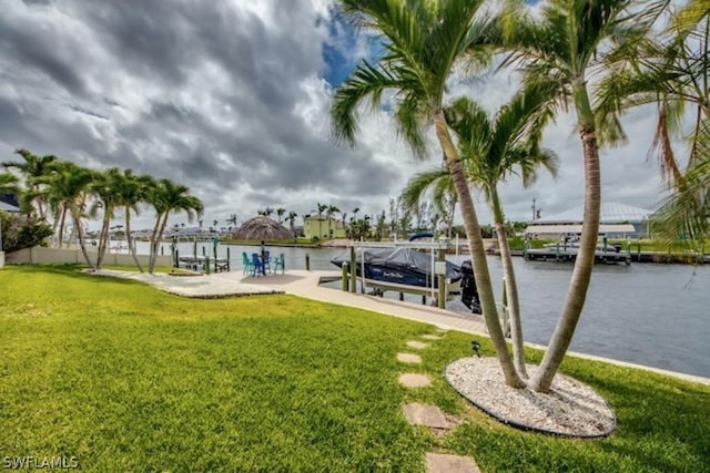 view of yard featuring a boat dock and a water view