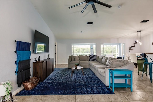 tiled living room featuring ceiling fan and vaulted ceiling