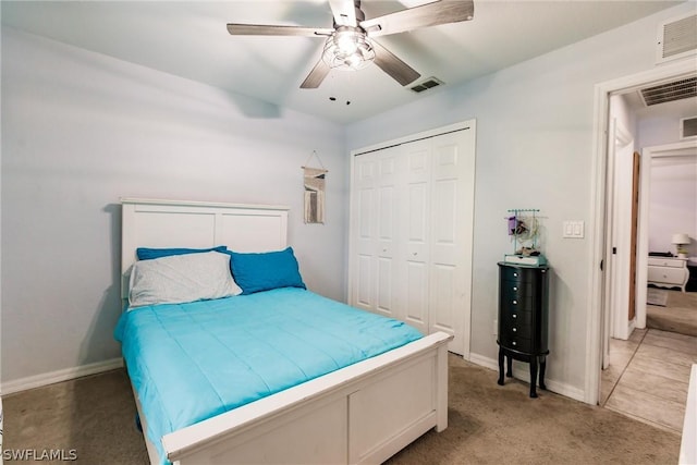 carpeted bedroom featuring a closet and ceiling fan