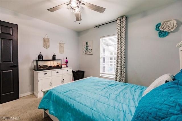 bedroom with ceiling fan and light colored carpet