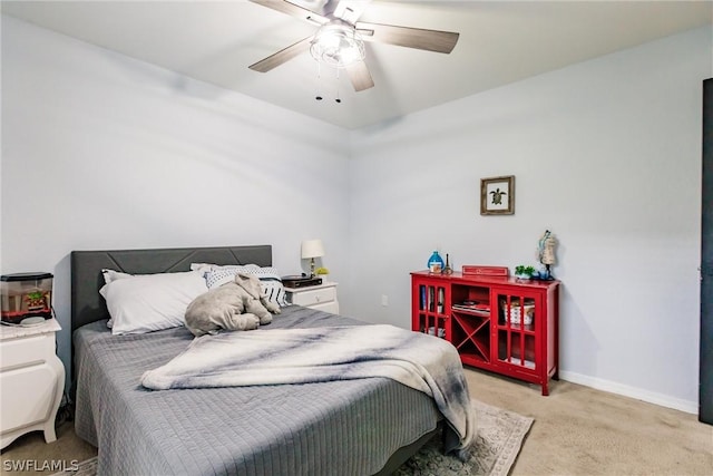 bedroom featuring ceiling fan and light carpet