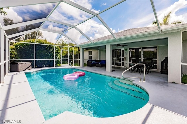 view of swimming pool featuring a lanai, ceiling fan, a patio, and an outdoor hangout area