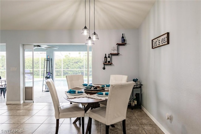 dining area with ceiling fan and light tile patterned flooring