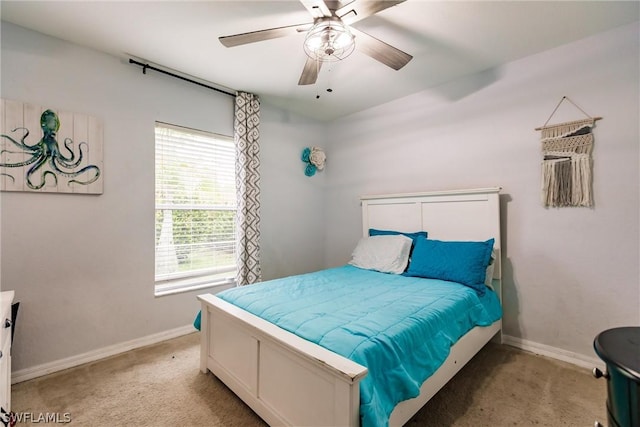 bedroom with multiple windows, light colored carpet, and ceiling fan