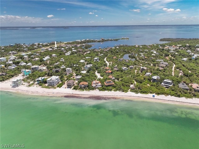 birds eye view of property featuring a view of the beach and a water view