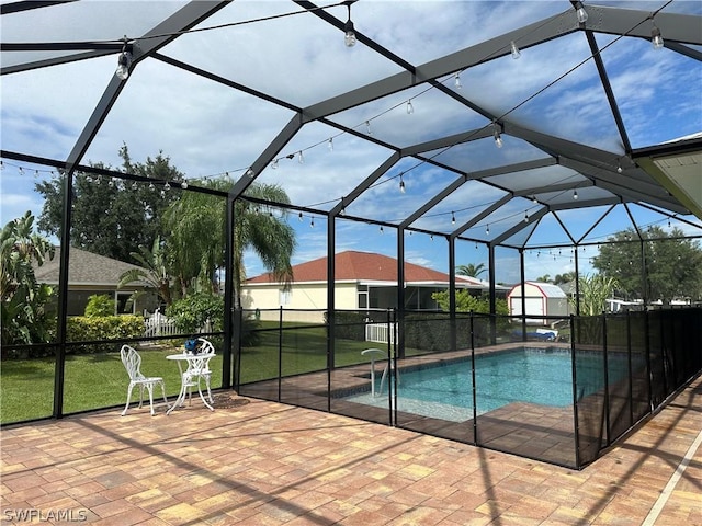 view of swimming pool with a lanai, a lawn, and a patio