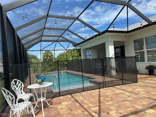 view of pool with a lanai and a patio area