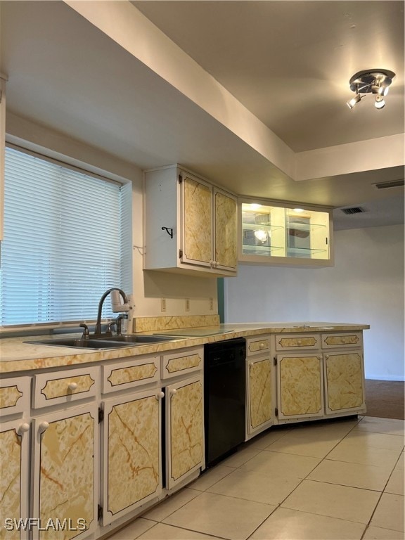 kitchen with dishwasher, light tile patterned floors, and sink