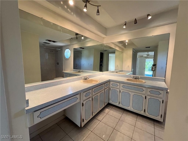 bathroom with tile patterned floors, ceiling fan, walk in shower, and vanity