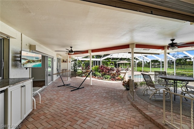 view of patio / terrace with glass enclosure and a pool