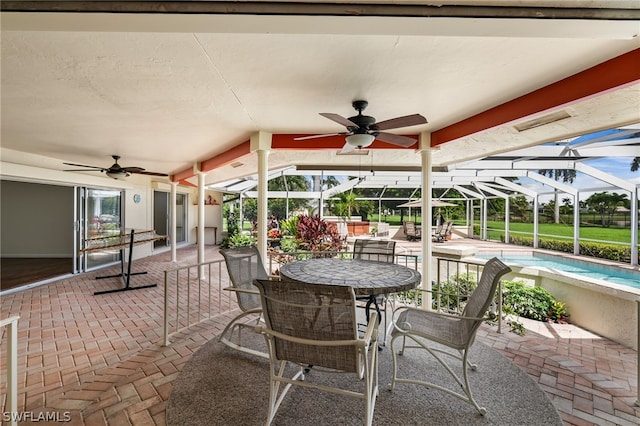 view of patio / terrace featuring a lanai and ceiling fan