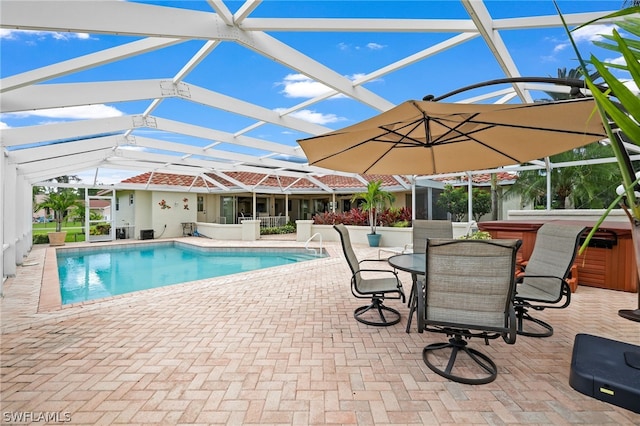 view of swimming pool featuring a lanai and a patio