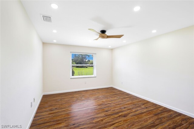 empty room featuring ceiling fan and dark hardwood / wood-style flooring