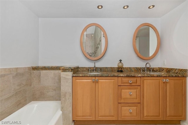 bathroom with a bath and vanity