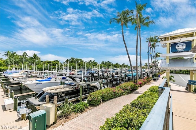 view of home's community with a water view and a dock