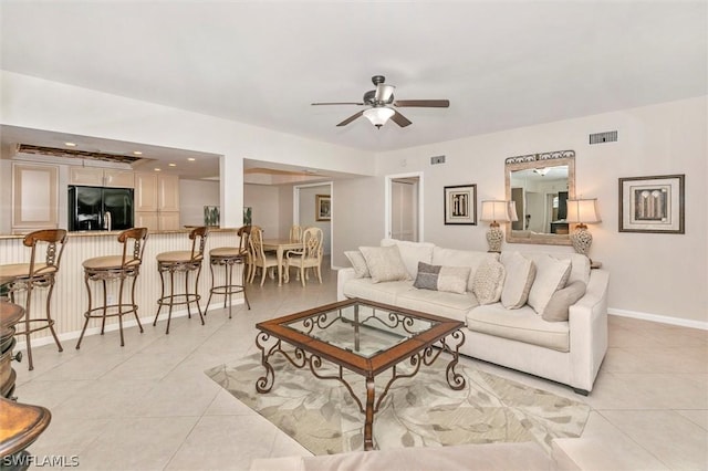 living room with ceiling fan and light tile patterned floors