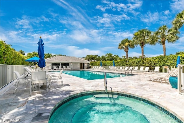 view of swimming pool with a community hot tub and a patio