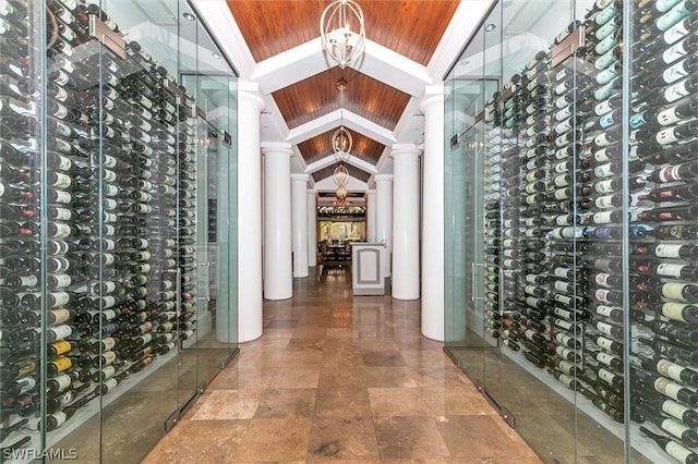 wine cellar with lofted ceiling, crown molding, wood ceiling, and a chandelier