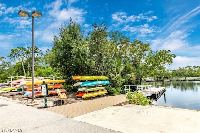 view of home's community with a boat dock and a water view