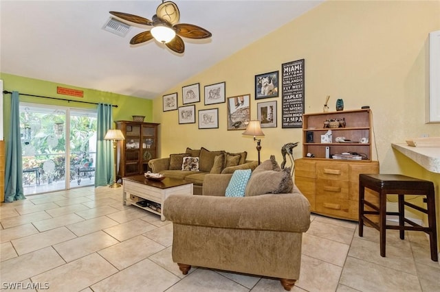 living room featuring ceiling fan, lofted ceiling, and light tile patterned floors