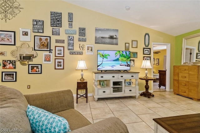 living room featuring light tile patterned floors and vaulted ceiling