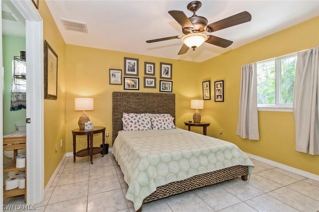 tiled bedroom featuring ceiling fan