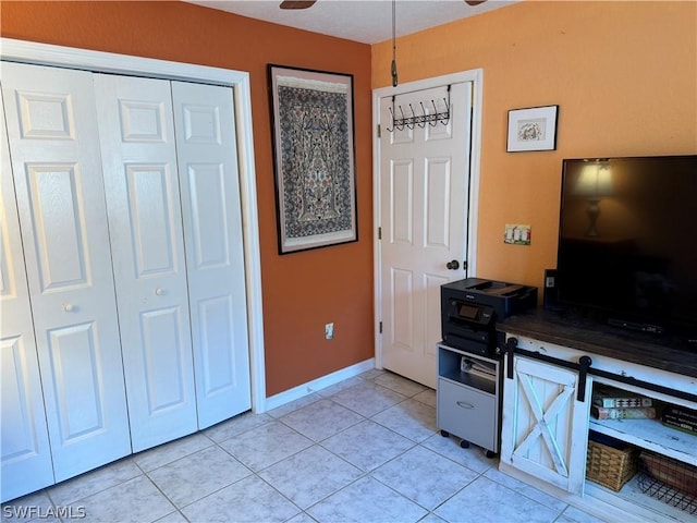 interior space featuring ceiling fan and light tile patterned floors