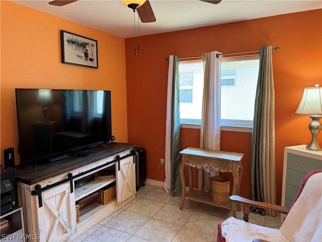 living room featuring ceiling fan and light tile patterned flooring