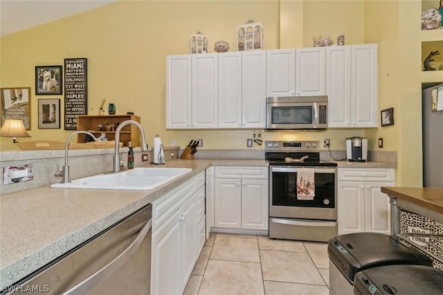 kitchen featuring white cabinets, sink, and appliances with stainless steel finishes