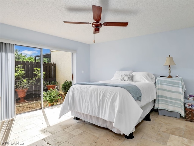 bedroom with a textured ceiling, access to outside, and ceiling fan