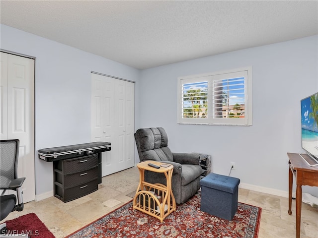 sitting room featuring a textured ceiling