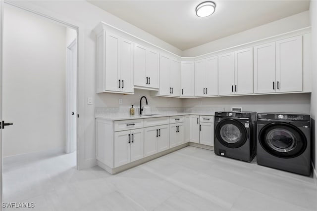 washroom featuring washer and clothes dryer, light tile patterned floors, cabinets, and sink