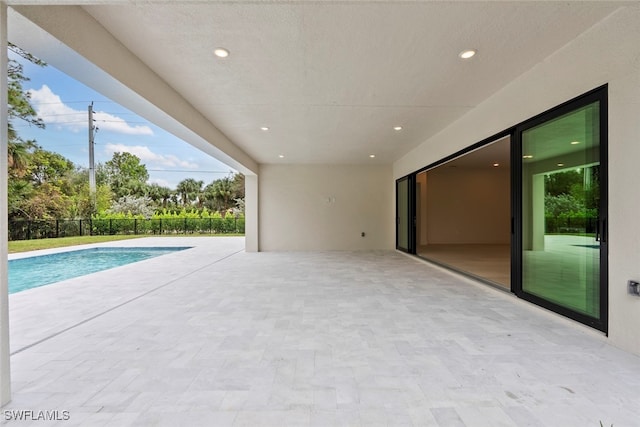 view of swimming pool featuring a patio area