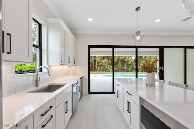 kitchen with white cabinetry, sink, and plenty of natural light