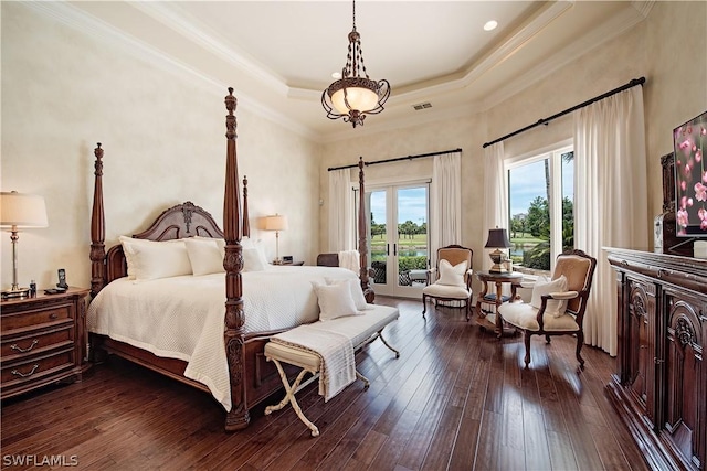 bedroom with french doors, crown molding, access to exterior, a tray ceiling, and dark hardwood / wood-style flooring