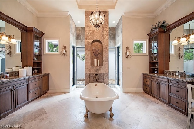 bathroom with a bathing tub, crown molding, vanity, and a notable chandelier