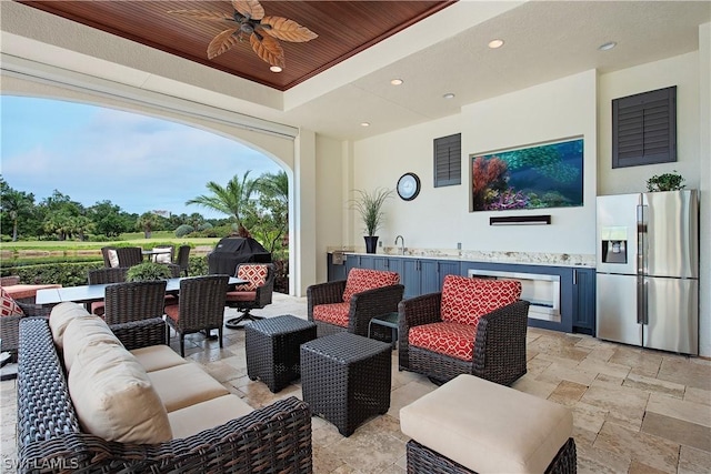 view of patio with outdoor lounge area, ceiling fan, a grill, and sink