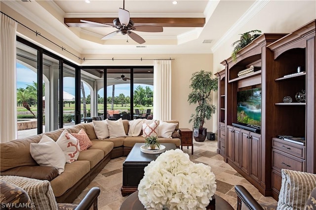 living room with a raised ceiling and ceiling fan