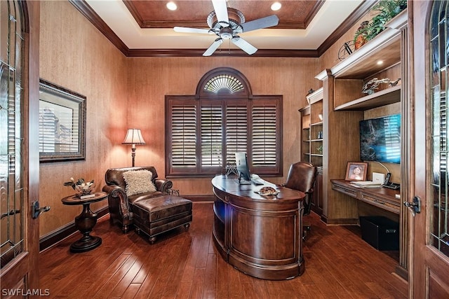 office space with a tray ceiling, dark hardwood / wood-style floors, and ornamental molding