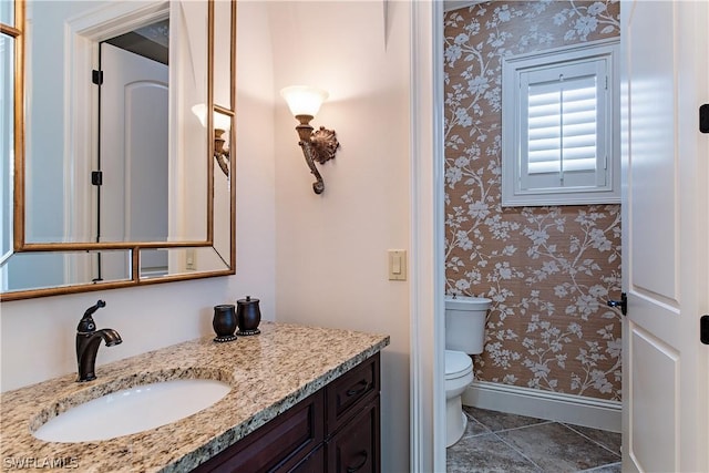 bathroom featuring tile patterned flooring, vanity, and toilet