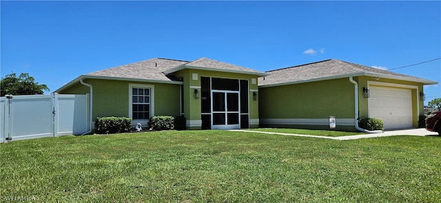 view of front of house featuring a front yard and a garage